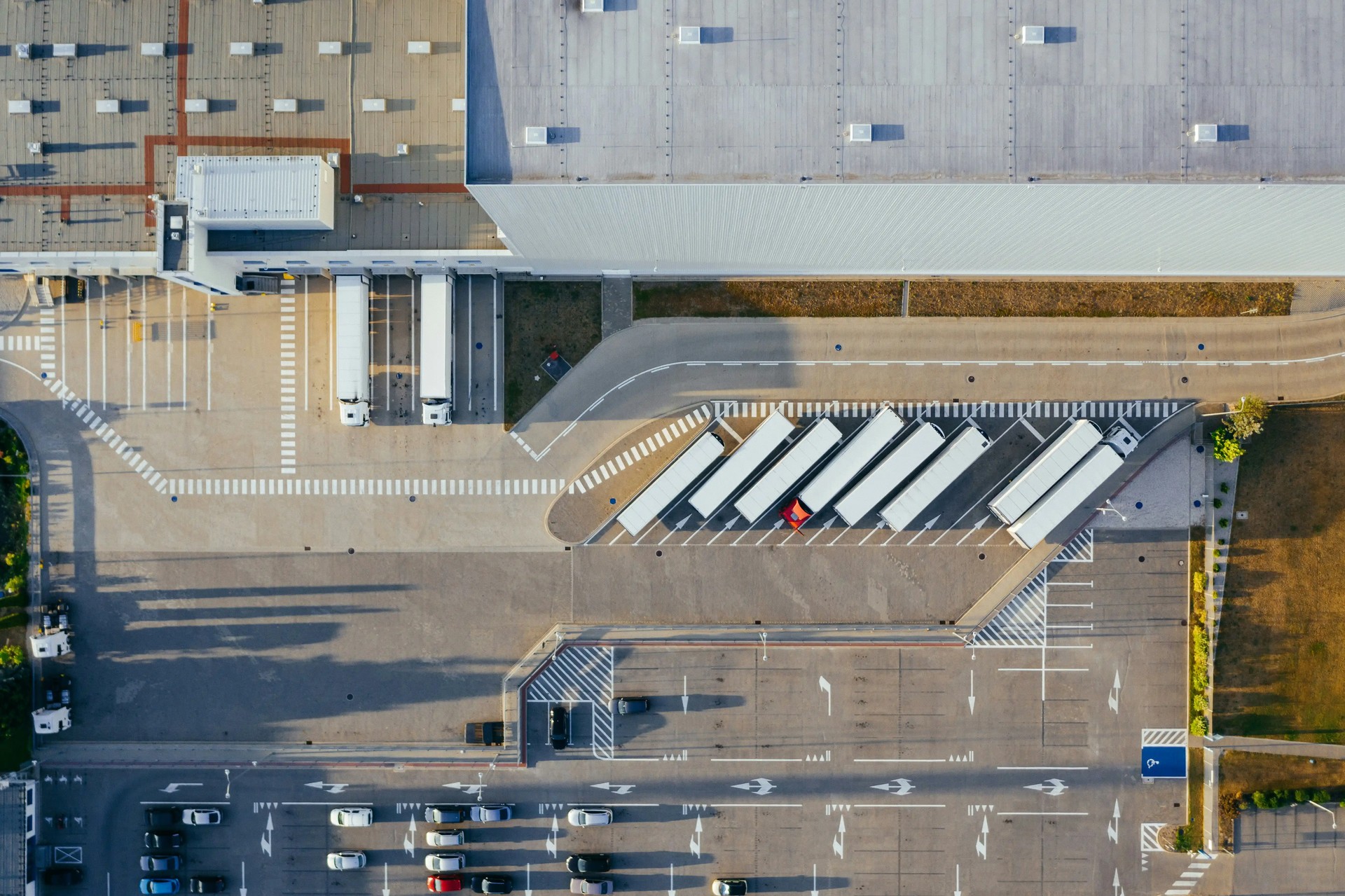 An overhead view of large vehicles and trailers at a port